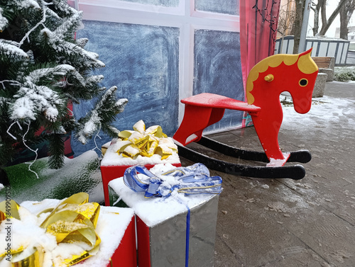 Christmas interior with red rocking horse, gifts and winter decor
