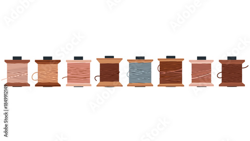 Colorful spools of thread are neatly arranged in a row, showcasing various shades and textures for sewing and crafting projects.