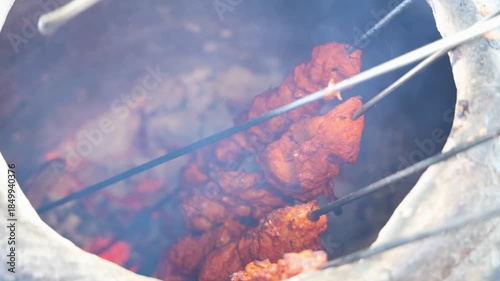 tandoori chicken skewers roasting inside traditional clay oven
