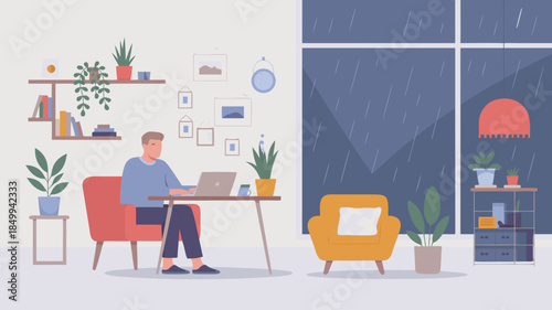 Man working on laptop at home during a rainy day, cozy indoor scene