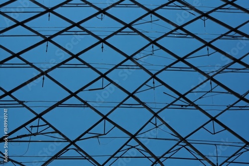 Abstract Diamond Pattern Roof Structure Against Blue Sky
