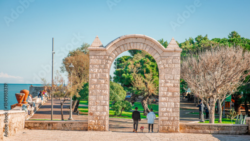 Photos A free-standing, pointed limestone archway marks the entrance to a lush seaside park in Trani