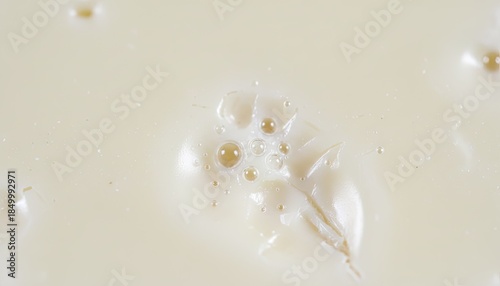 Close Up Macro Shot Of A Single Dried Leaf Floating In A Light Creamy Liquid With Small Bubbles And Speckles Of Light In Soft Natural Lighting
