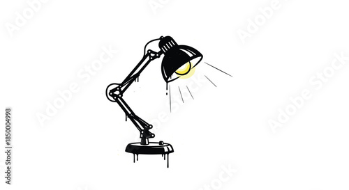 Industrial desk lamp in a black and white graffiti style shows a warm yellow glow from the light bulb with paint drips.