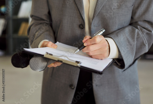 Photos Holding microphone and clipboard for interview, woman writing notes with pen, pr