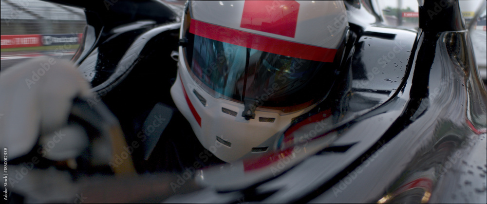 Fototapeta premium A close-up of a race car driver in motion, captured while speeding on a track