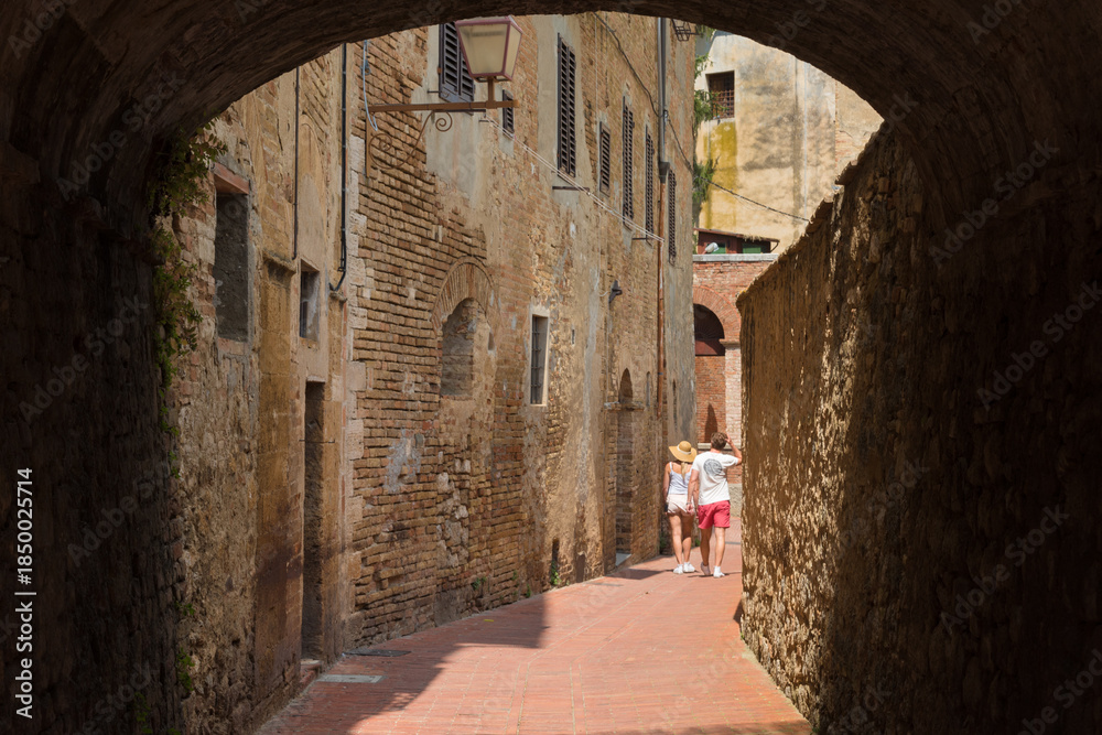 Fototapeta premium Children in Medieval Alley, San Gimignano Italy