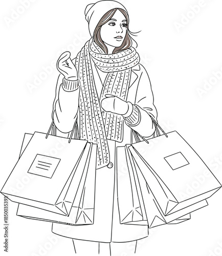 Stylish young woman dressed warmly for winter shopping holding numerous branded retail bags and looking away thoughtfully