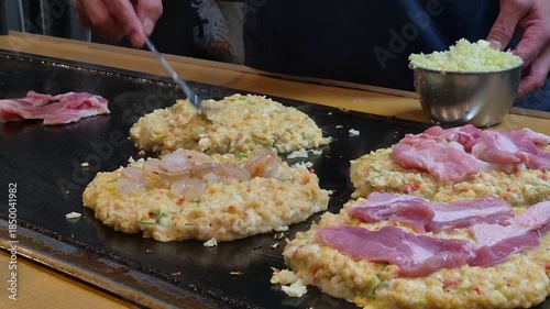 Freshly cook okonomiyaki Japanese style pizza on hot plate Osaka street food