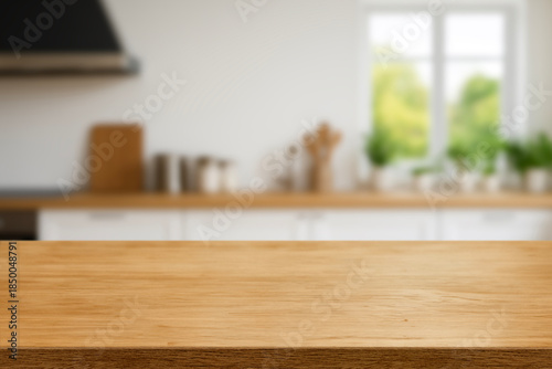Kitchen wood table top for product display with blurred modern interior. Wooden tabletop over defocused kitchen background. kitchen furniture and desk space. product promotion in the kitchen
