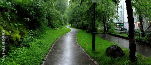 Explore the beauty of a green park with trees and grass in Gothenburg, Sweden, showcasing nature within the city during a rainy day