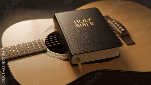 Holy Bible resting on an acoustic guitar. Christian worship music and songwriting concept. Close up of religious book and wooden instrument