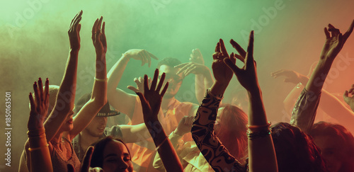 Quadro em tela Crowd dancing together in vibrant club environment