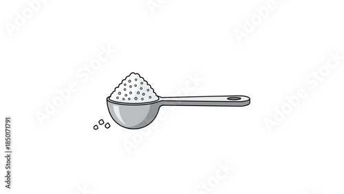 Measuring spoon filled with granulated substance, possibly sugar or salt, shown against a plain white background.