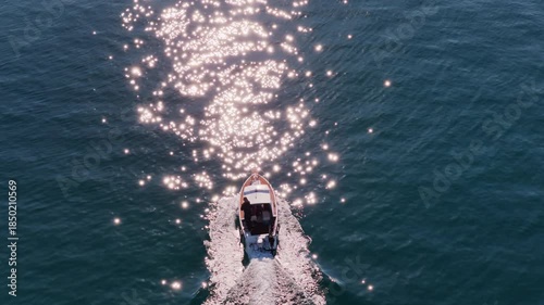 Wallpaper Mural Aerial drone view of a small motorboat speeding across the water, leaving a white foamy trail behind it on the calm turquoise sea. Biograd na Moru, Croatia Torontodigital.ca