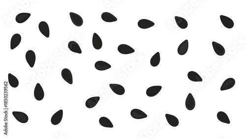 Scattered black seeds on a white background