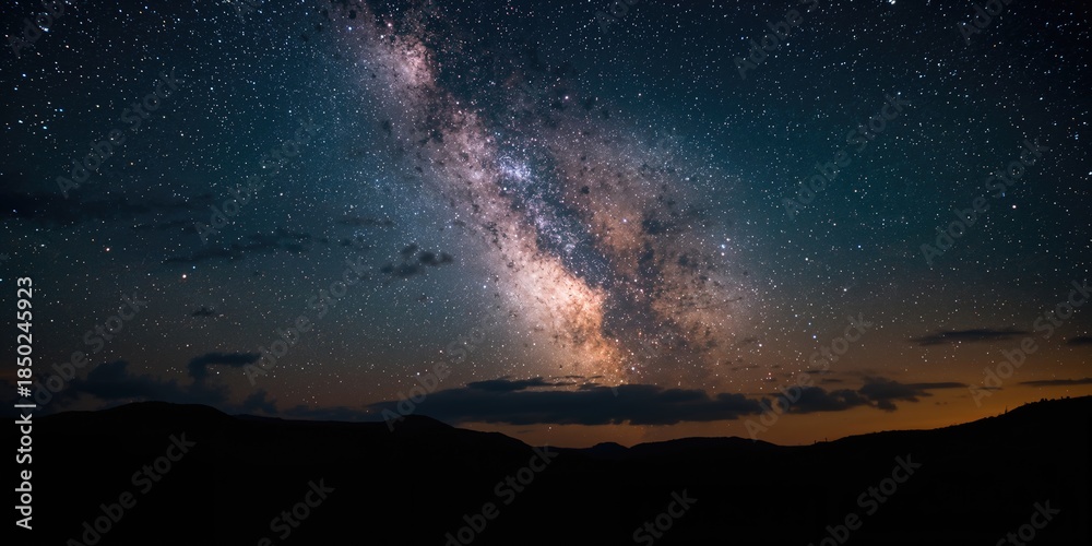 Fototapeta premium Night sky featuring a long exposure of the Milky Way, emphasizing star movement for astronomy applications