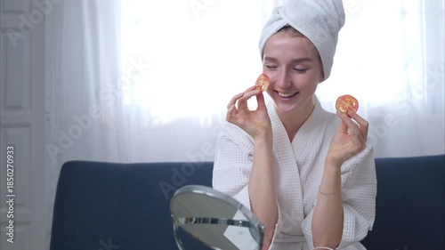 Young woman with natural facial skin care activities such as tomatoes
