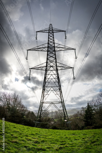 
National grid electricity pylon against a cloudy, sky. Power generation and infrastructure. Electricity network and power distribution