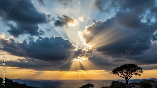 Sun rays breaking through dark clouds, hope and perseverance.