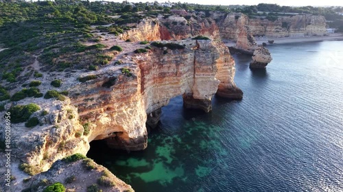 Portugal algarve aerial view of coastal cliffs and turquoise water at sunrise or sunset