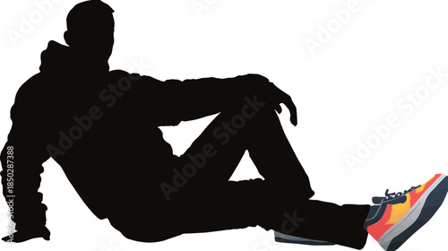 Stylish casual man silhouette sitting relaxed on the ground, showcasing a vibrant colorful athletic sneaker shoe.