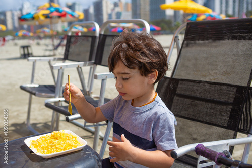 4 year old boy eating boiled corn