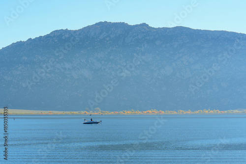 Peaceful Lake Perris Waters With Mountain And Solo Boat