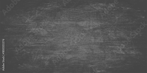 Aged black chalkboard surface with a dark grunge texture and rough vintage pattern provides a blank gray backdrop for art