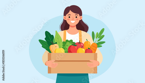 Woman holding a box of fresh fruits and vegetables.