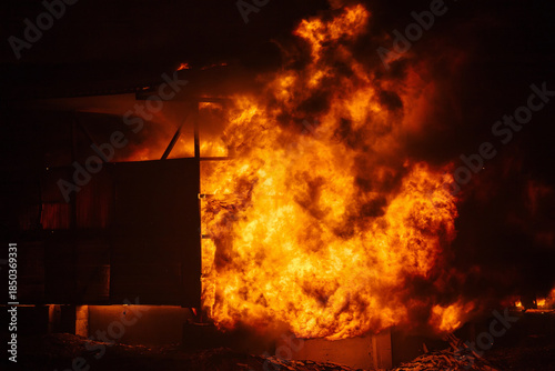 Exploding and burning building. Big blaze at night