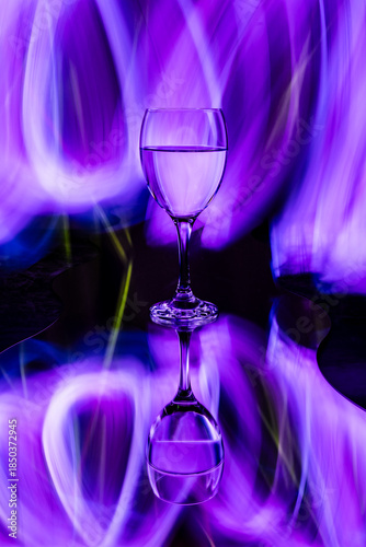 Abstract light painting with wine glass and reflection.