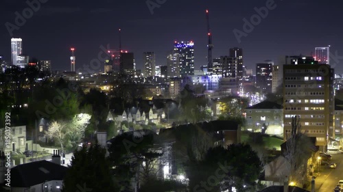 Birmingham City Skyline at Night - 2025.
A wide night time view of the Birmingham city skyline, showcasing illuminated high-rise buildings, residential areas, and construction cranes.