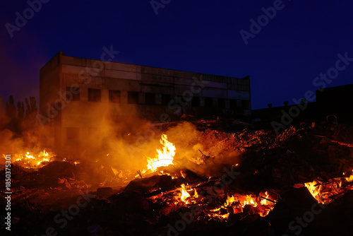 Принти на полотні Burning building ruins at night after fire or attack