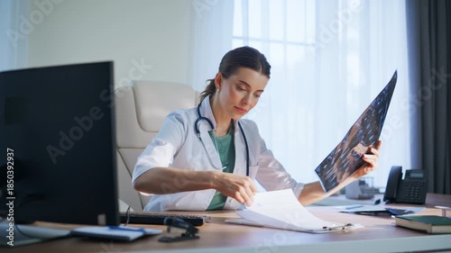 Satisfied woman radiologist studying scan clinic. Happy doctor analyzing x-ray