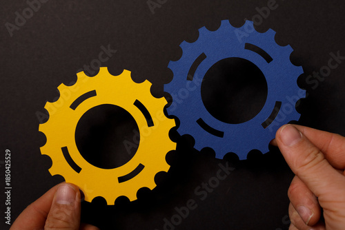 Two hands holding yellow an...