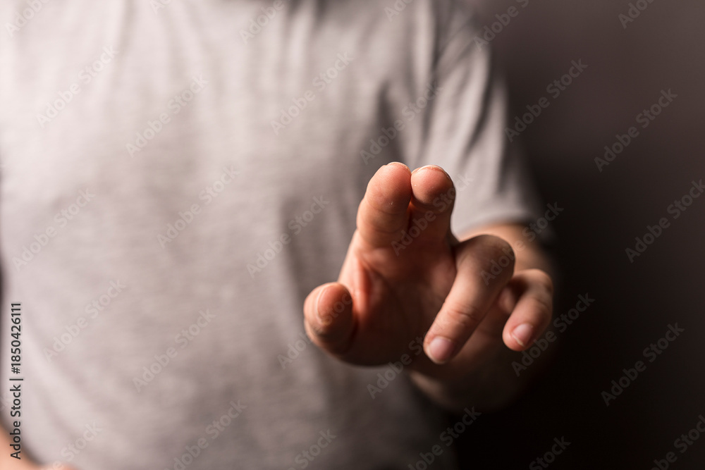 Obraz premium Close up of a hand pointing or touching with a blurred background. Perfect for concepts of touch, interaction, o