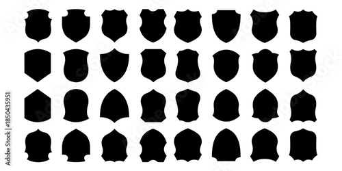 Collection of black shield badge silhouettes isolated on white background