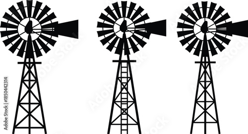 Windmill silhouettes, mechanical wind power, rural energy, lattice tower design, rotor blades, water pumping, black and white illustration, renewable infrastructure