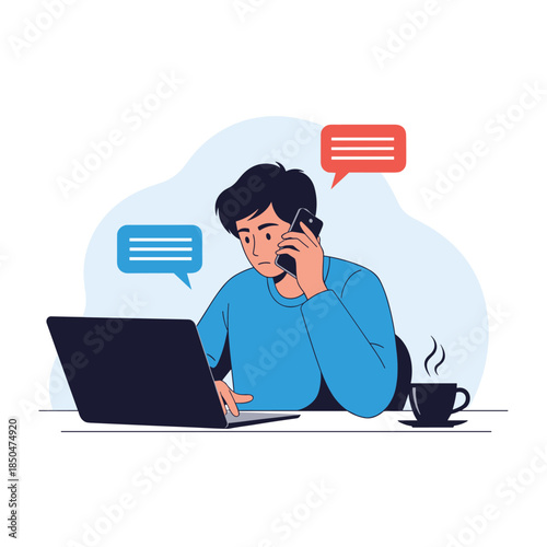 Young man multitasking by talking on a smartphone while working on a laptop with a cup of coffee at his desk.
