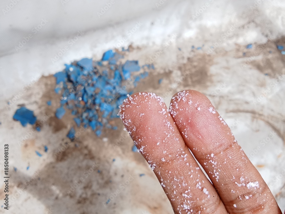 Fototapeta premium Microplastic particles stick to fingers