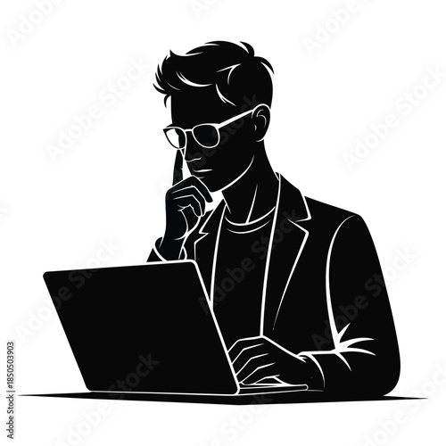 Young man in glasses working intently on a laptop, thoughtfully touching his chin while concentrating on complex tasks or information on screen