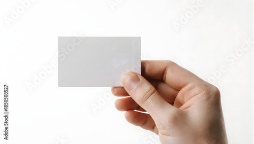 Business Card in Hand: A close-up shot of a hand gracefully holding a blank business card. perfect for illustrating concepts of contact, identity, and networking.
