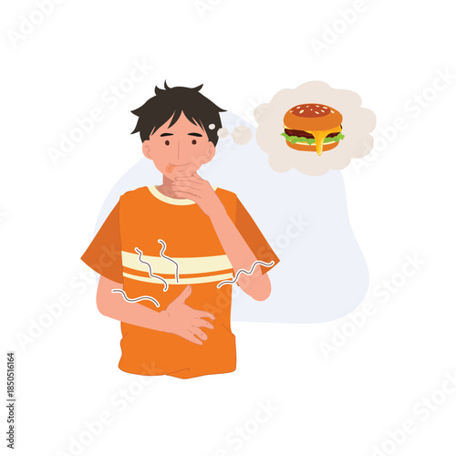young man experiencing stomach ache and hunger while thinking about a burger