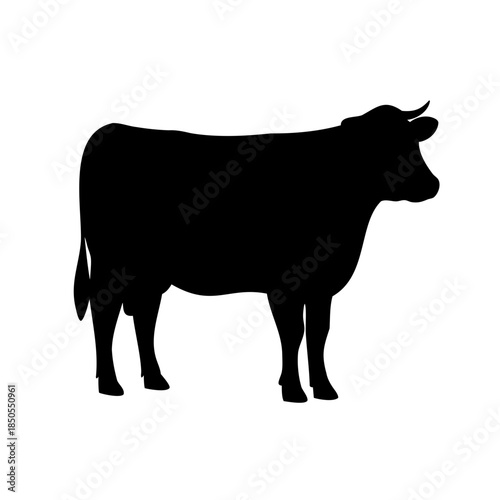 A powerful black silhouette of a horned cow standing, facing right
