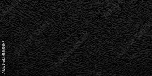 A dark textured black leather background featuring a rough macro pattern and old skin structure design for a textile material surface backdrop