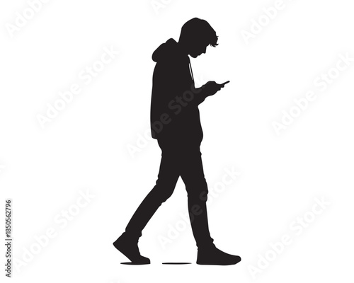 Silhouette of young man walking and looking at smartphone screen