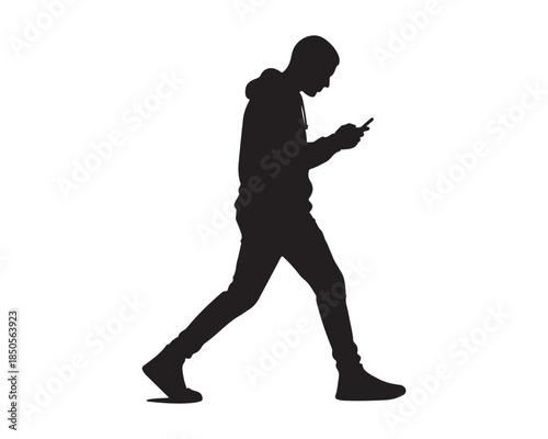 Young Male Silhouette Walking and Texting on Mobile Phone