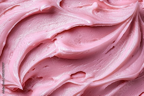 close-up of smooth swirls of pink frosting with glossy peaks evoking sweet playful indulgence