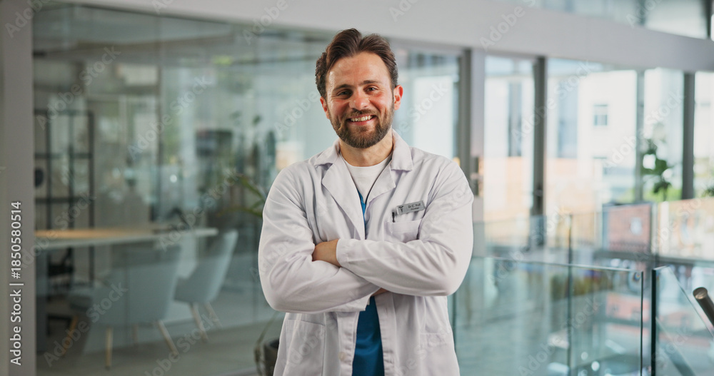Fototapeta premium Portrait, smile and doctor with arms crossed in hospital for career pride, about us and medical service. Happy, man or job ambition for healthcare assistance, patient care and confidence for wellness